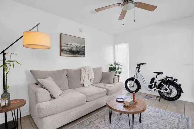 a living room with furniture a clock and a window