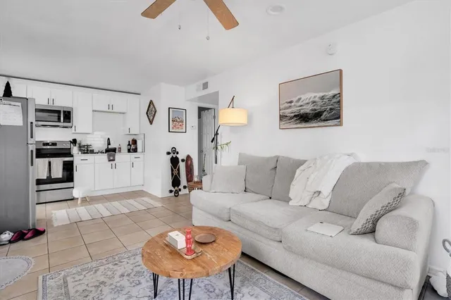 a living room with furniture and kitchen view