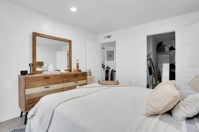 a bedroom with a bed and a mirror