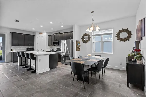 a view of a dining room and livingroom with furniture window and wooden floor