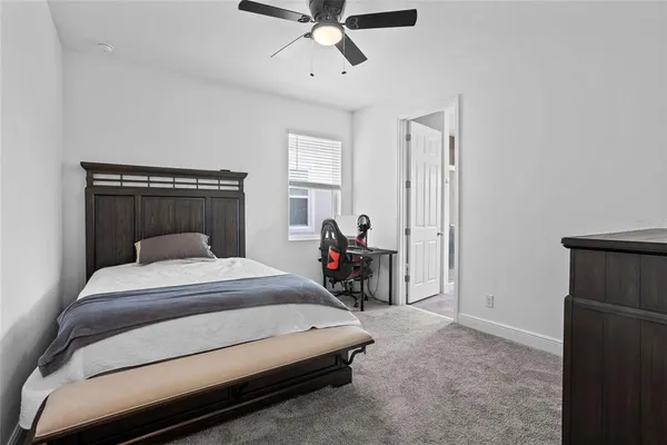 a bed room with a bed and a ceiling fan