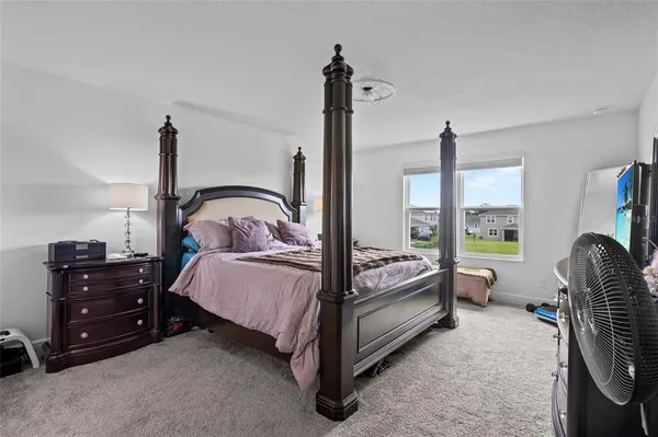 a bed room with a bed and a chair