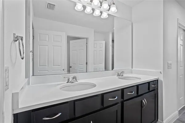 a bathroom with a sink double vanity and a mirror