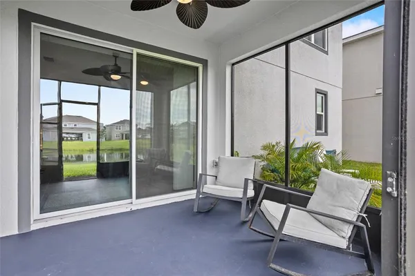 a living room with furniture and a floor to ceiling window