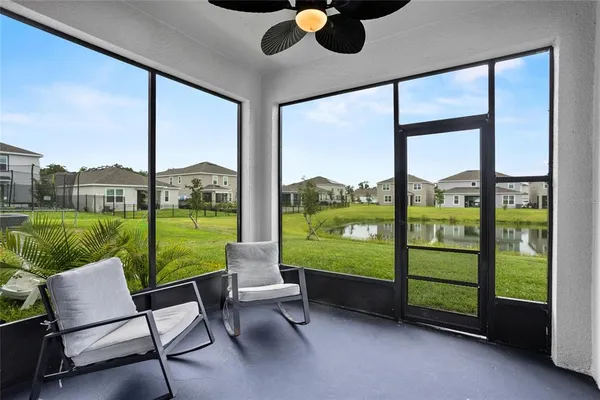 a living room with furniture and a floor to ceiling window