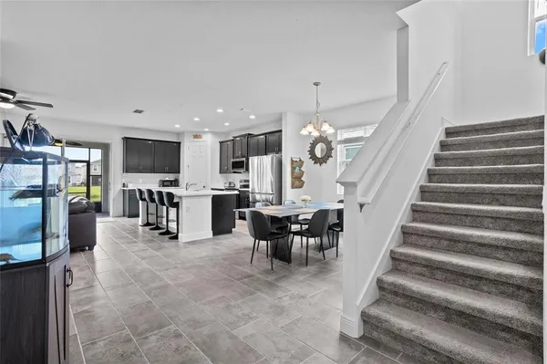 a view of a dining area with furniture and a kitchen