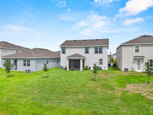 a backyard of a house with table and chairs