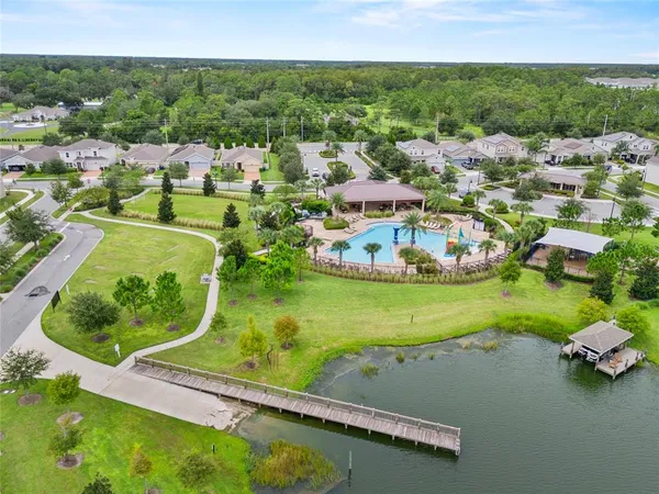 an aerial view of a house with yard swimming pool and outdoor seating