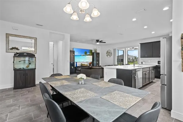 a kitchen with granite countertop a stove refrigerator and cabinets