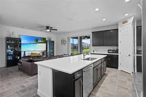 a kitchen with kitchen island stainless steel appliances a sink stove and refrigerator