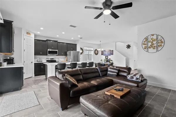 a living room with furniture and kitchen view