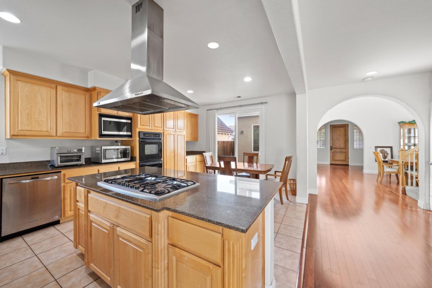 318 Rothbury Way San Ramon, CA 94582 - Photo 16 of 53 a kitchen with stainless steel appliances granite countertop a stove a sink dishwasher and white cabinets with wooden floor