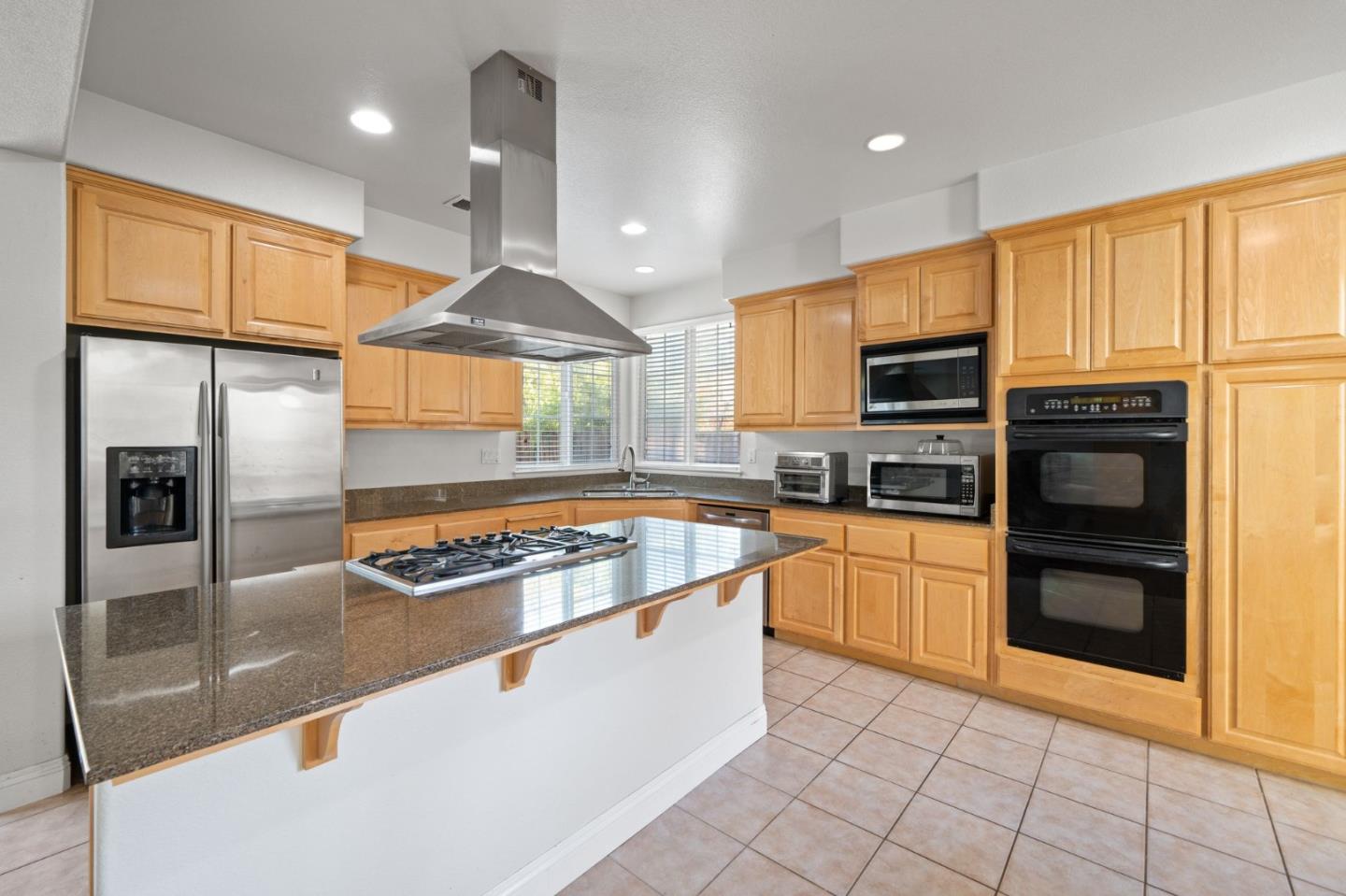 318 Rothbury Way San Ramon, CA 94582 - Photo 17 of 53 a kitchen with stainless steel appliances granite countertop a stove a sink and a refrigerator