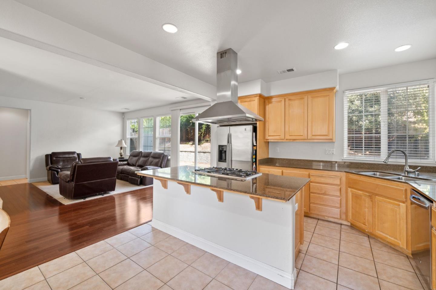 318 Rothbury Way San Ramon, CA 94582 - Photo 18 of 53 a large kitchen with stainless steel appliances a large counter top a stove a chimney a sink and a large window