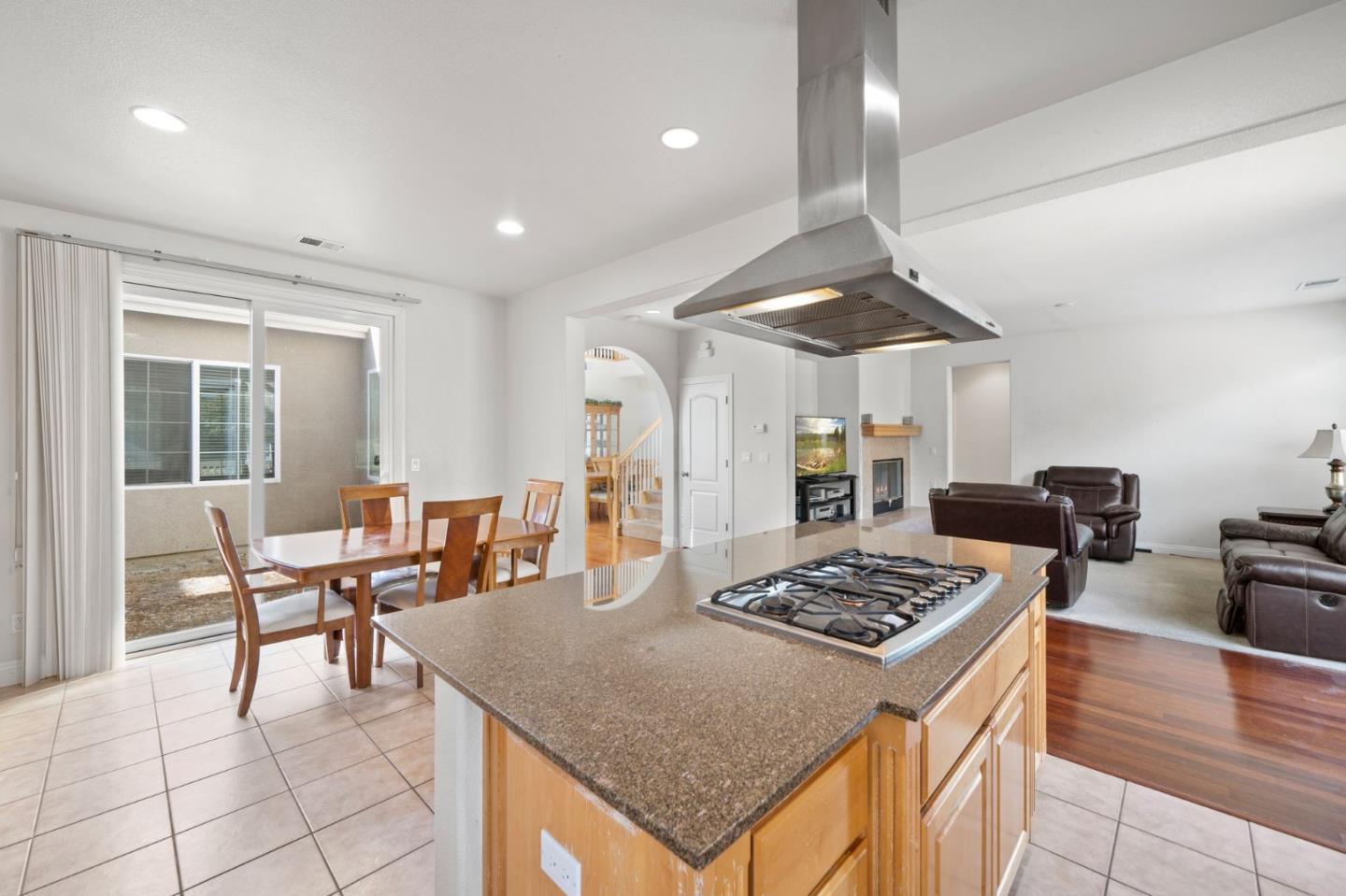 318 Rothbury Way San Ramon, CA 94582 - Photo 19 of 53 a kitchen with stainless steel appliances granite countertop a stove oven a dining table and chairs with wooden floor