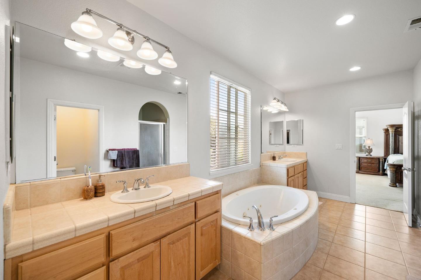 318 Rothbury Way San Ramon, CA 94582 - Photo 35 of 53 a en suite bathroom with a granite countertop sink and a mirror