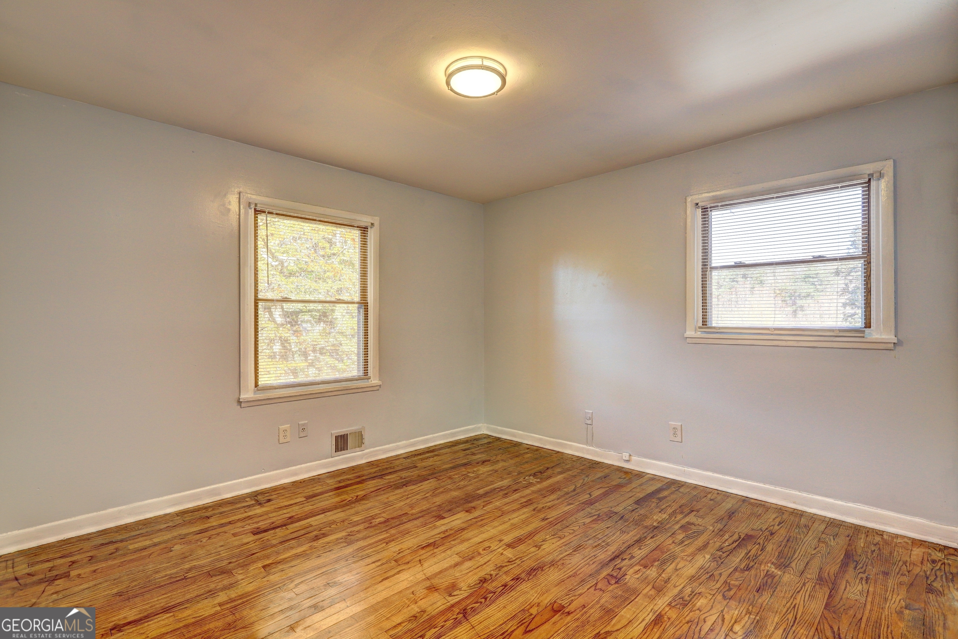 2270 Cresta Drive Decatur, GA 30032 - Photo 18 of 26 an empty room with wooden floor and windows