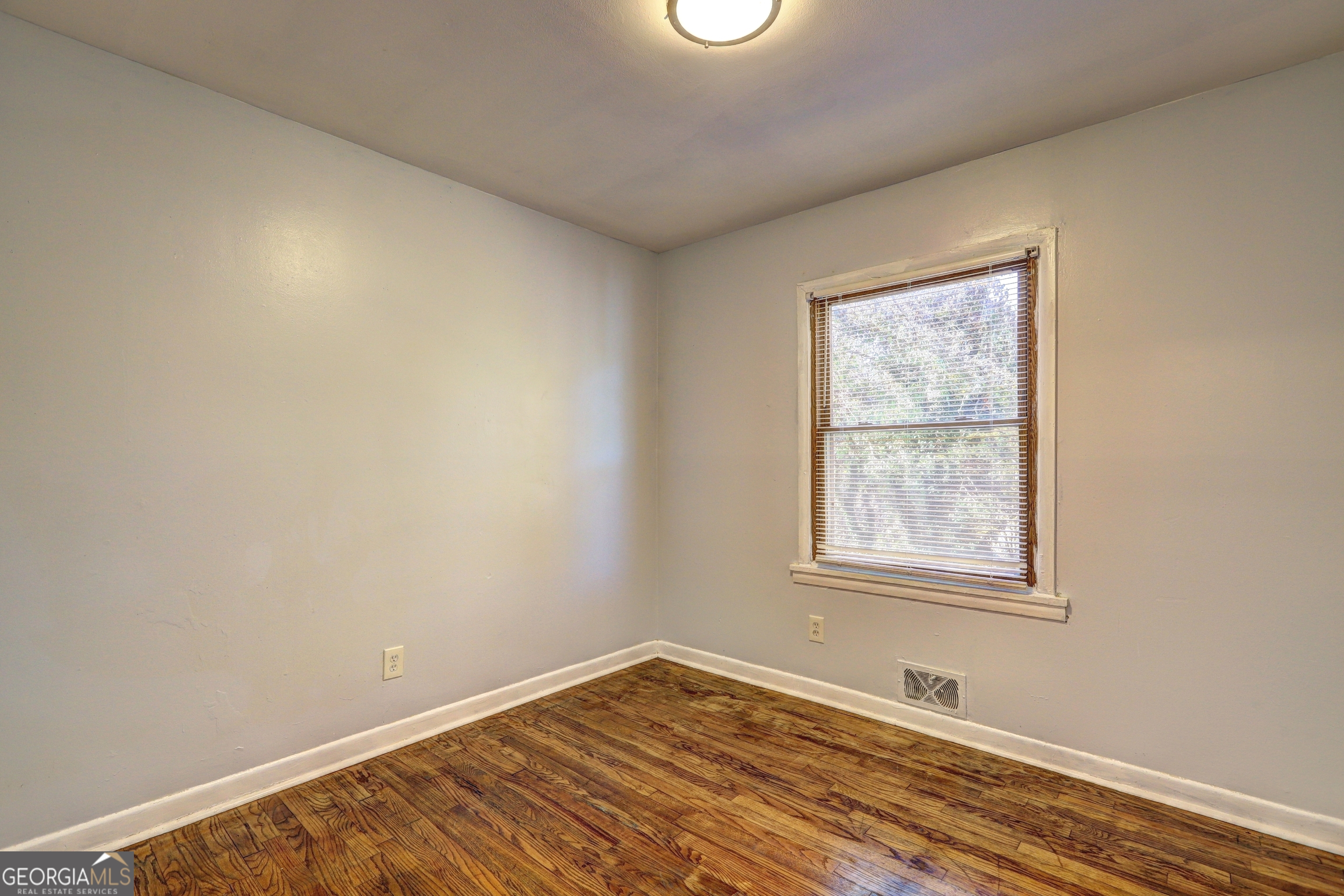 2270 Cresta Drive Decatur, GA 30032 - Photo 21 of 26 an empty room with wooden floor and windows