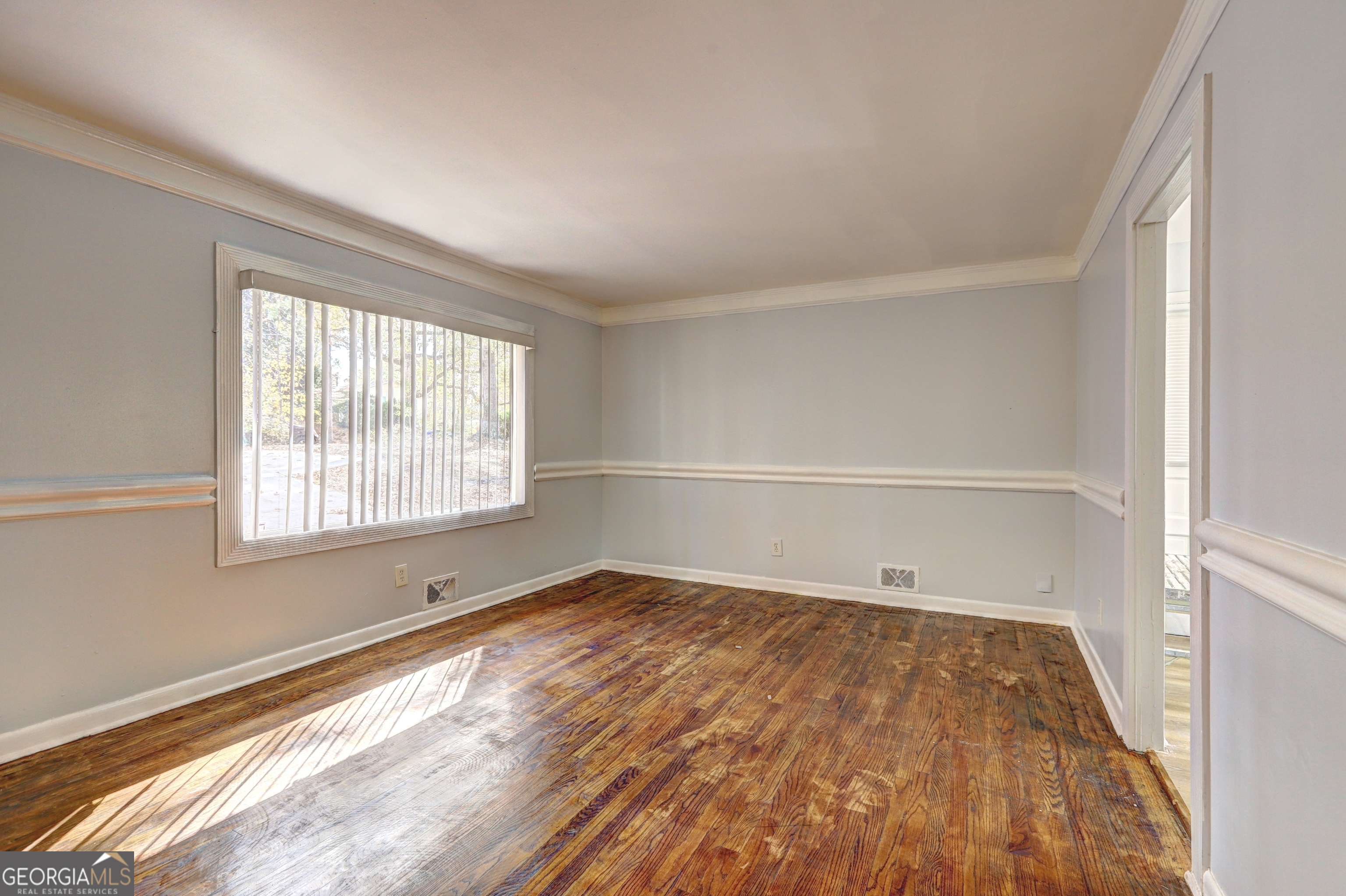 2270 Cresta Drive Decatur, GA 30032 - Photo 4 of 26 a view of an empty room with wooden floor and a window