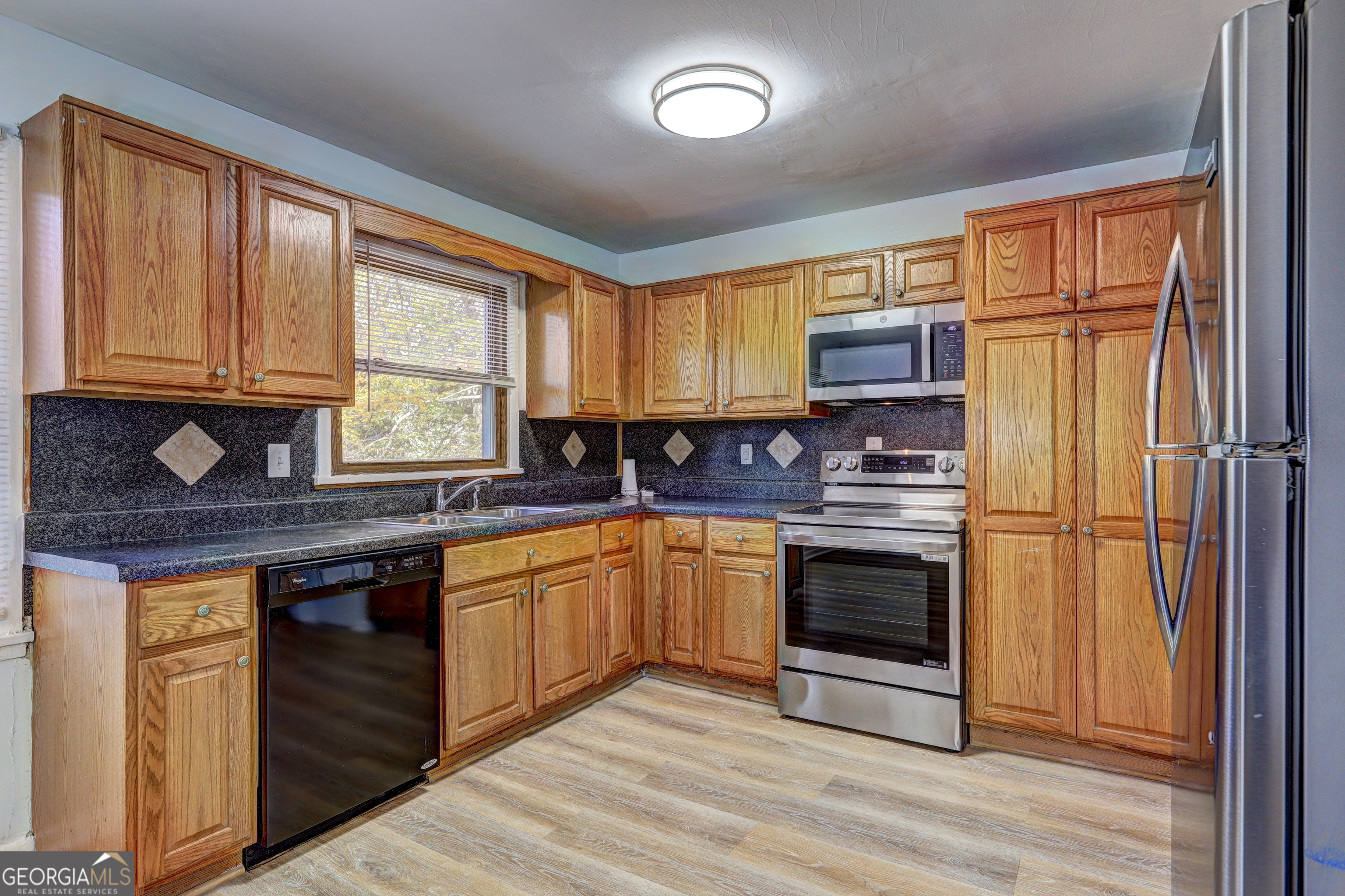 2270 Cresta Drive Decatur, GA 30032 - Photo 6 of 26 a kitchen with stainless steel appliances granite countertop a stove a sink and a refrigerator
