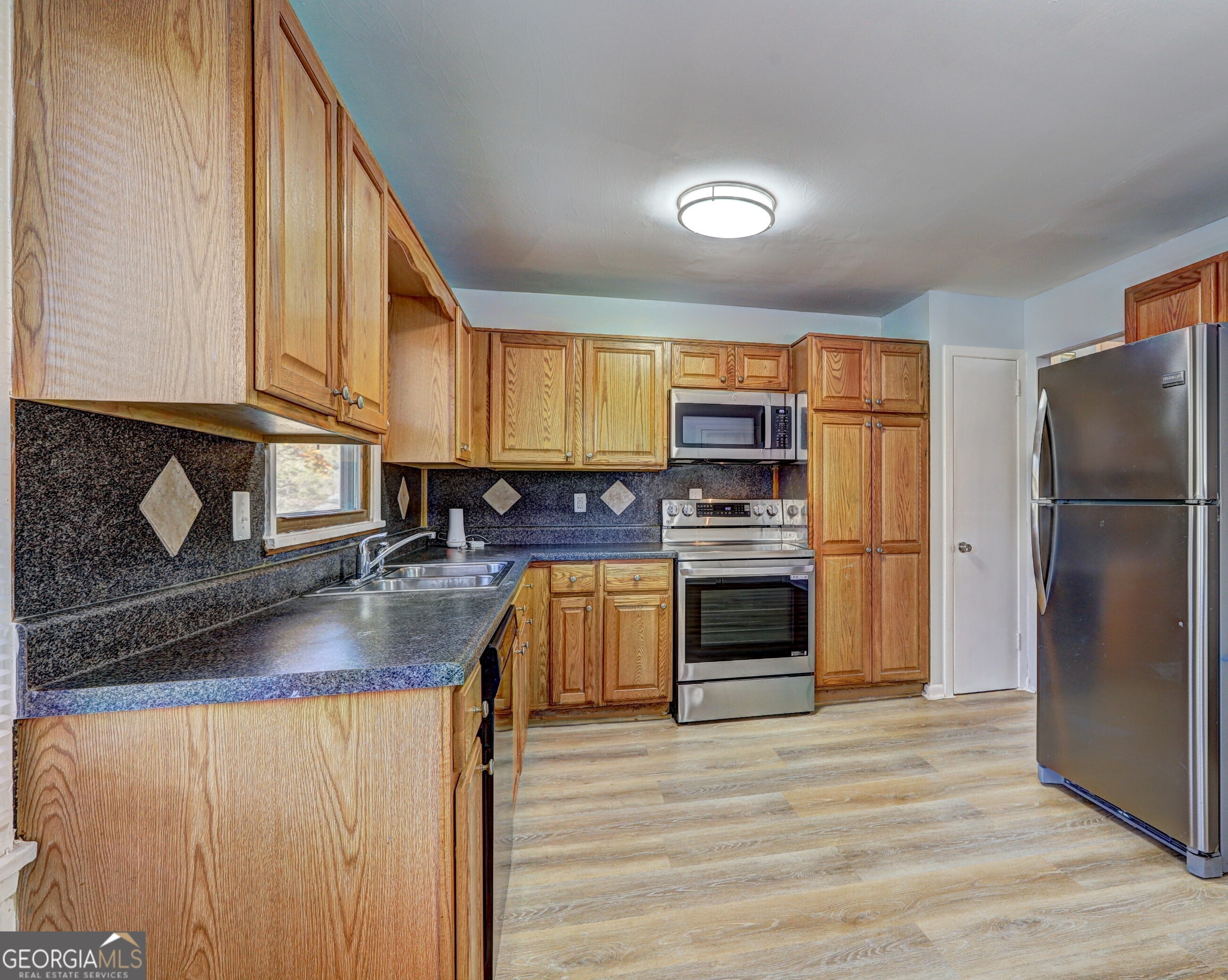 2270 Cresta Drive Decatur, GA 30032 - Photo 7 of 26 a kitchen with stainless steel appliances granite countertop a refrigerator a stove top oven a sink and dishwasher