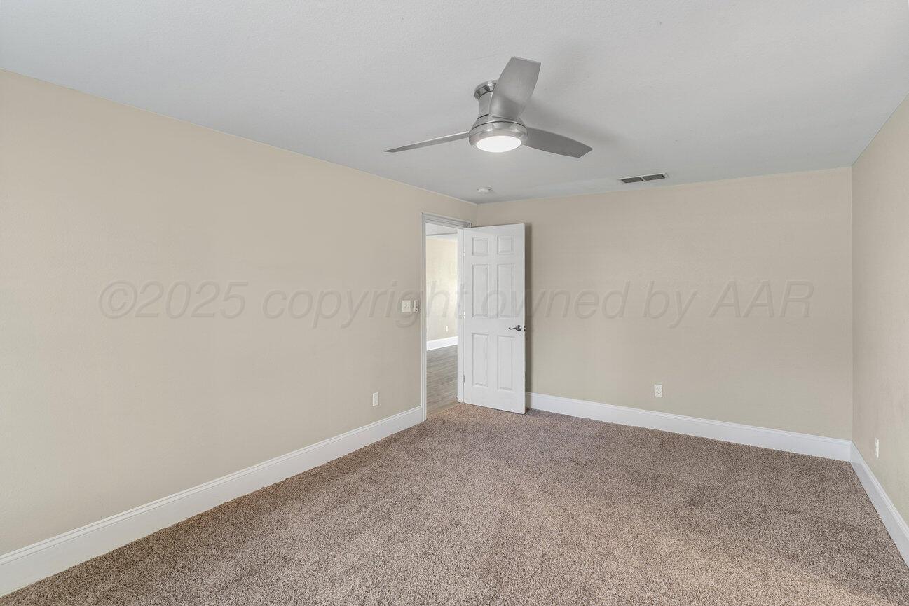 4436 South Travis Street Amarillo, TX 79110 - Photo 15 of 29 a view of an empty room and chandelier fan