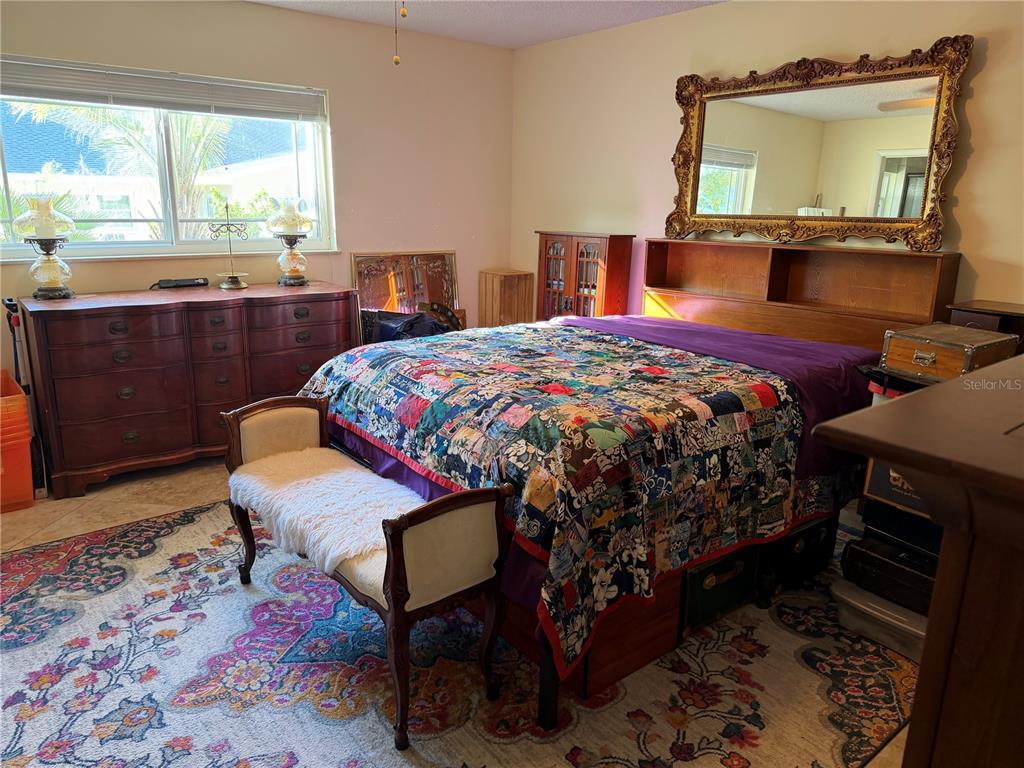 9529 Southwest 85th Avenue, Unit D Ocala, FL 34481 - Photo 10 of 21 a bedroom with a bed a flat screen tv and a window