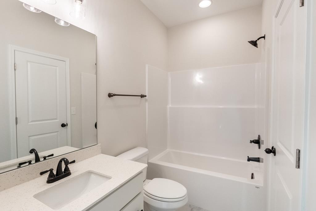 42 Hawkeye Trail Fortson, GA 31808 - Photo 12 of 29 a bathroom with a sink toilet a bathtub and shower