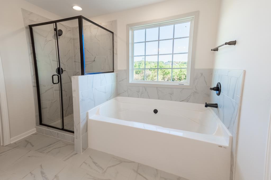42 Hawkeye Trail Fortson, GA 31808 - Photo 15 of 29 a white bath tub sitting next to a shower