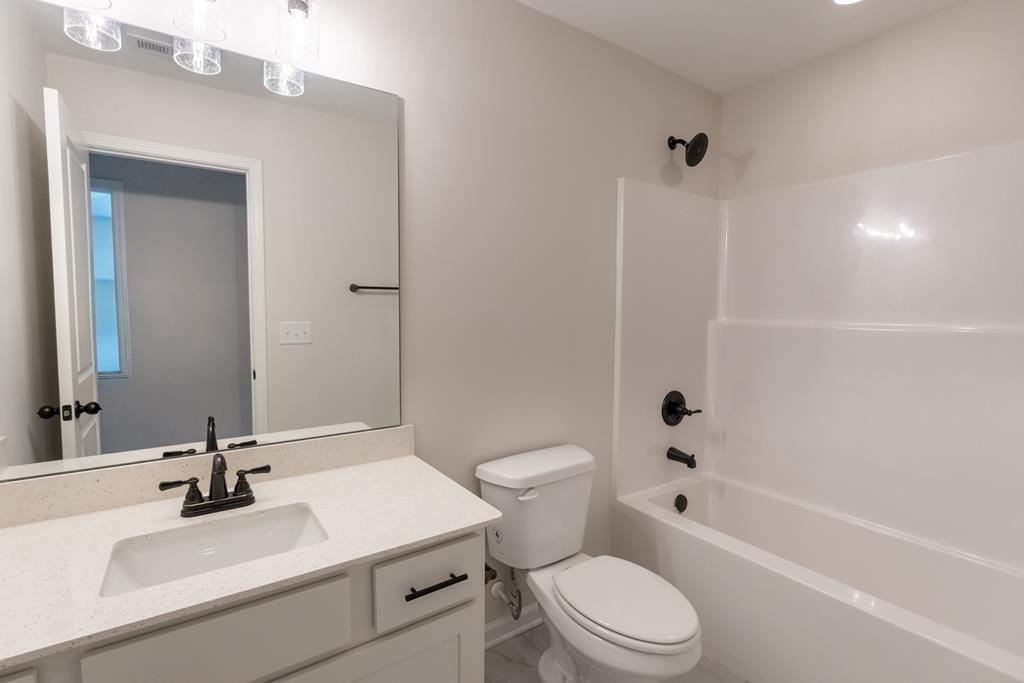 42 Hawkeye Trail Fortson, GA 31808 - Photo 21 of 29 a bathroom with a sink toilet vanity and shower