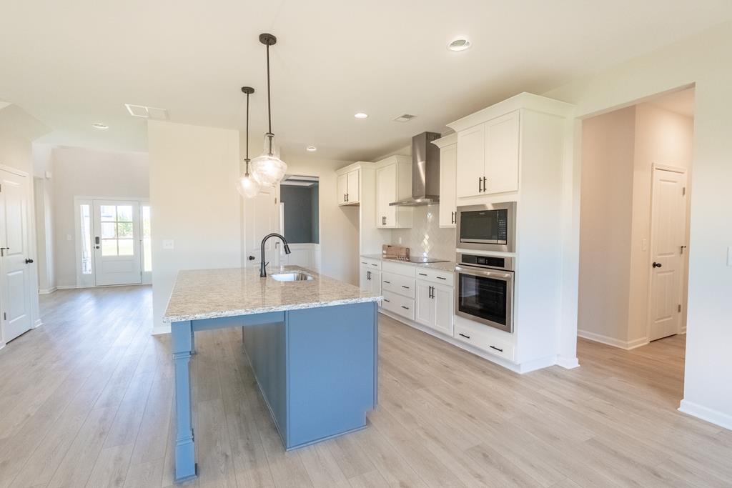 42 Hawkeye Trail Fortson, GA 31808 - Photo 7 of 29 a kitchen with stainless steel appliances kitchen island granite countertop a sink refrigerator and cabinets