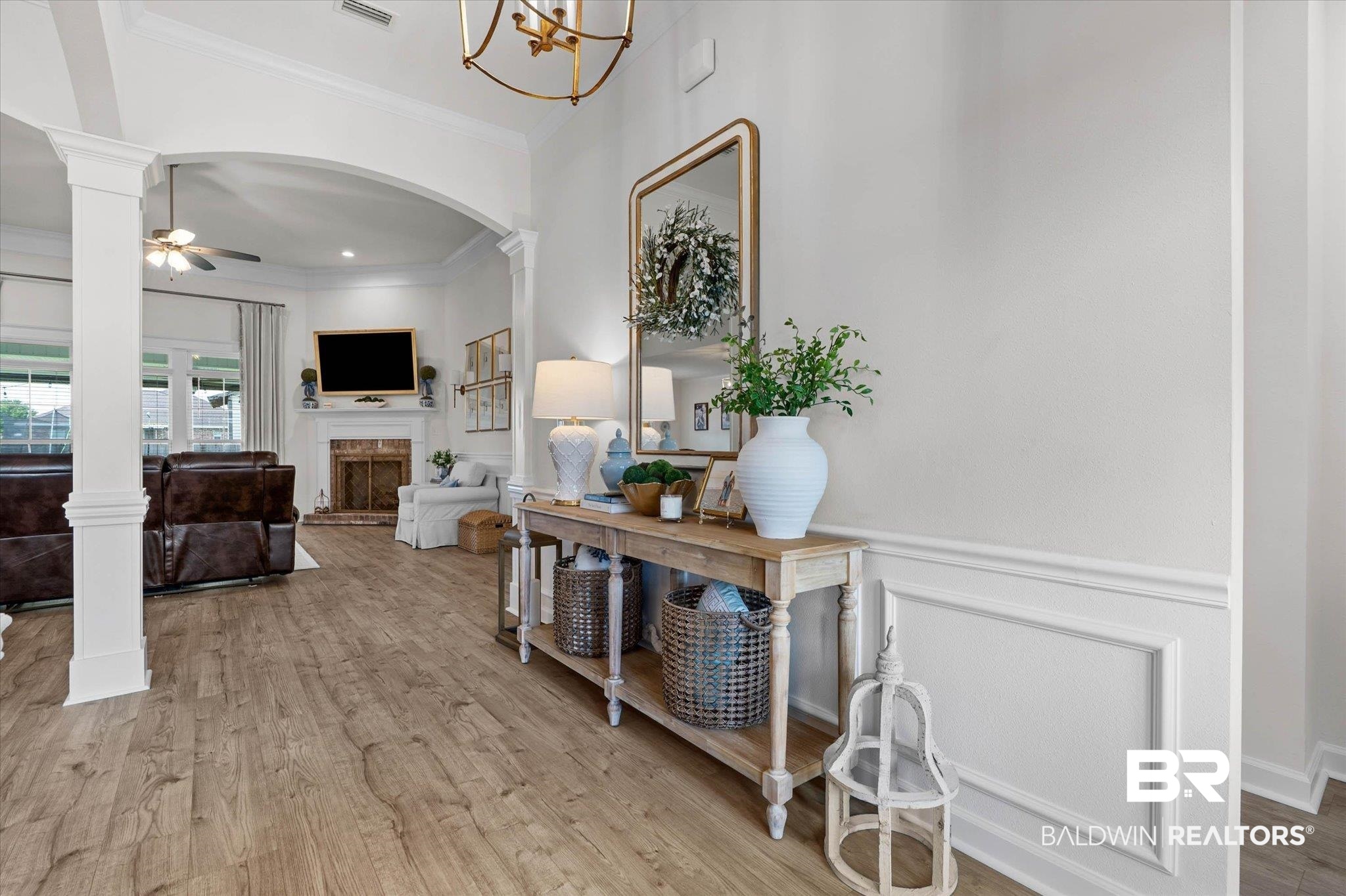 9074 Moses Way Theodore, AL 36582 - Photo 7 of 52 Spacious interior featuring wood-finish flooring, a decorative wall panel, and an arched entryway