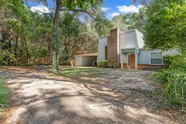 a front view of a house with a garden and yard