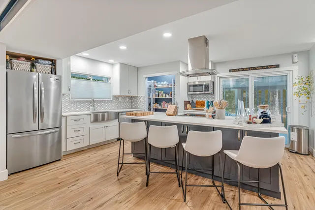 a kitchen with stainless steel appliances granite countertop a sink and a wooden cabinets