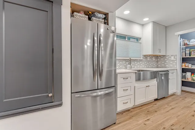 a stove top oven sitting inside of a kitchen