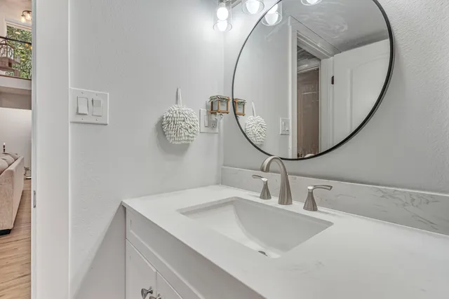 a bedroom with a large bed and a chandelier