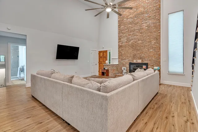 a view of empty room with wooden floor and fireplace
