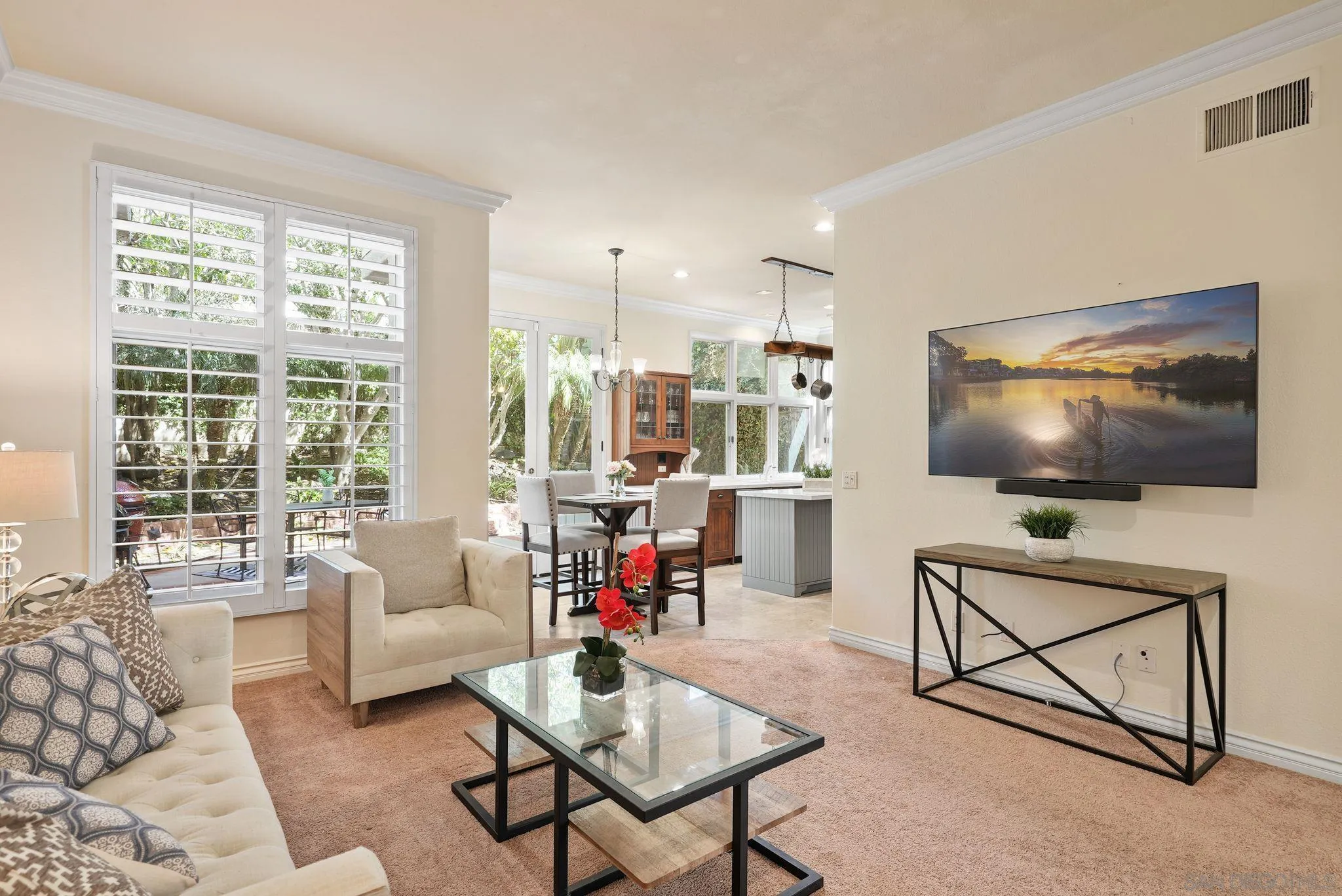 9683 Claiborne Square La Jolla, CA 92037 - Photo 17 of 67 a living room with furniture and a flat screen tv