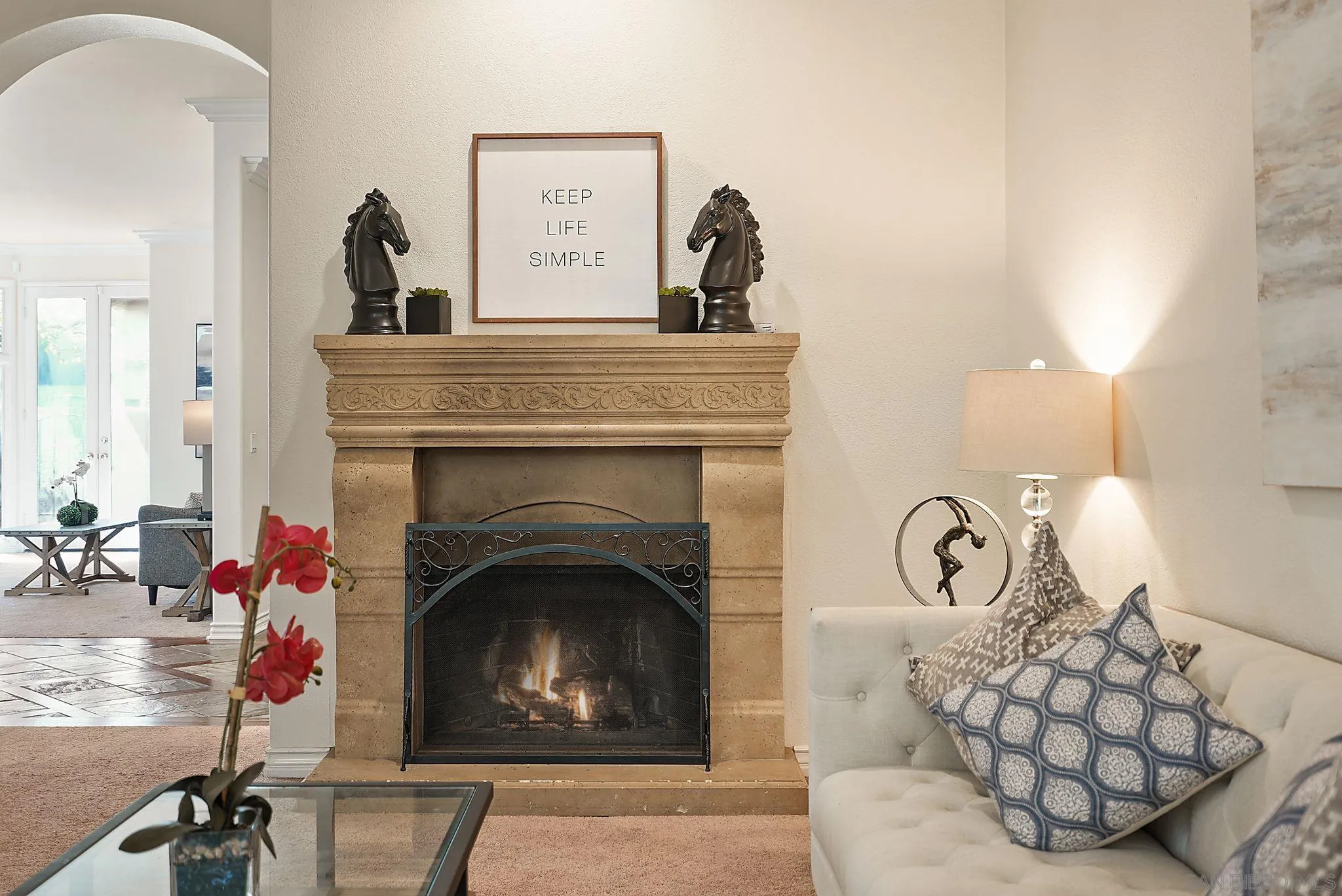 9683 Claiborne Square La Jolla, CA 92037 - Photo 20 of 67 a living room with furniture a fireplace and a potted plant