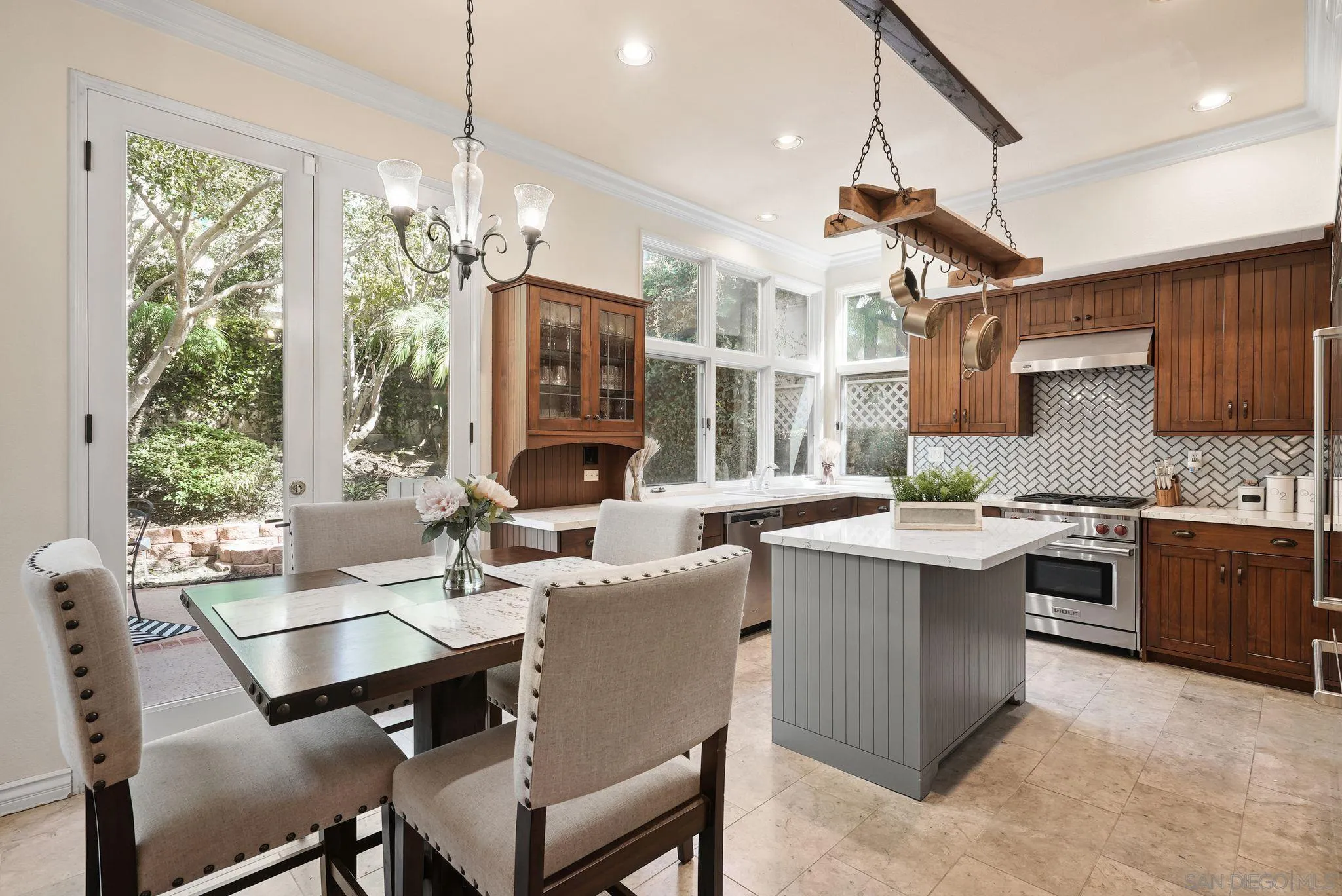 9683 Claiborne Square La Jolla, CA 92037 - Photo 21 of 67 a open kitchen with stainless steel appliances granite countertop a stove top oven a sink a counter space and dining table