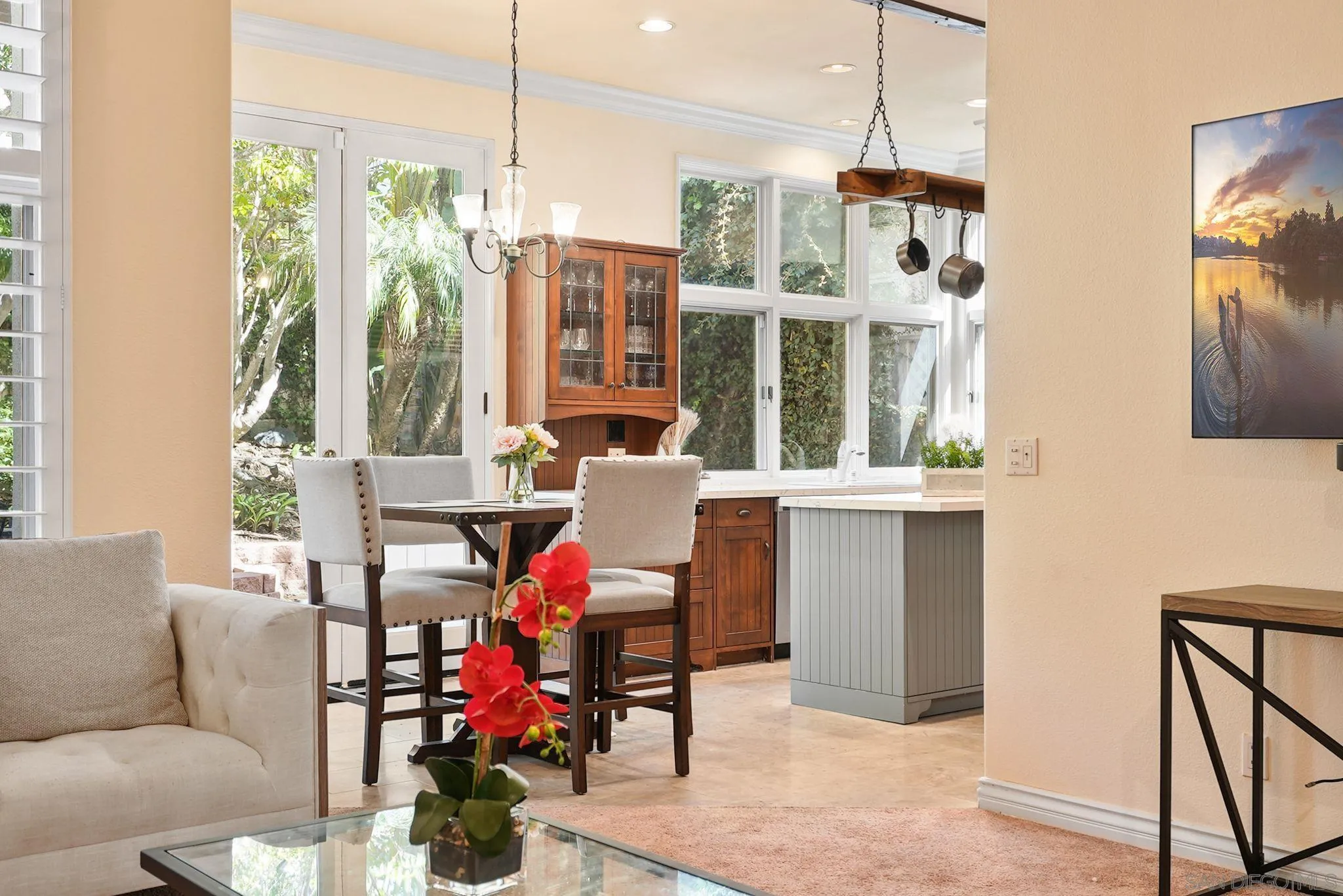 9683 Claiborne Square La Jolla, CA 92037 - Photo 22 of 67 a living room with furniture a chandelier and a large window