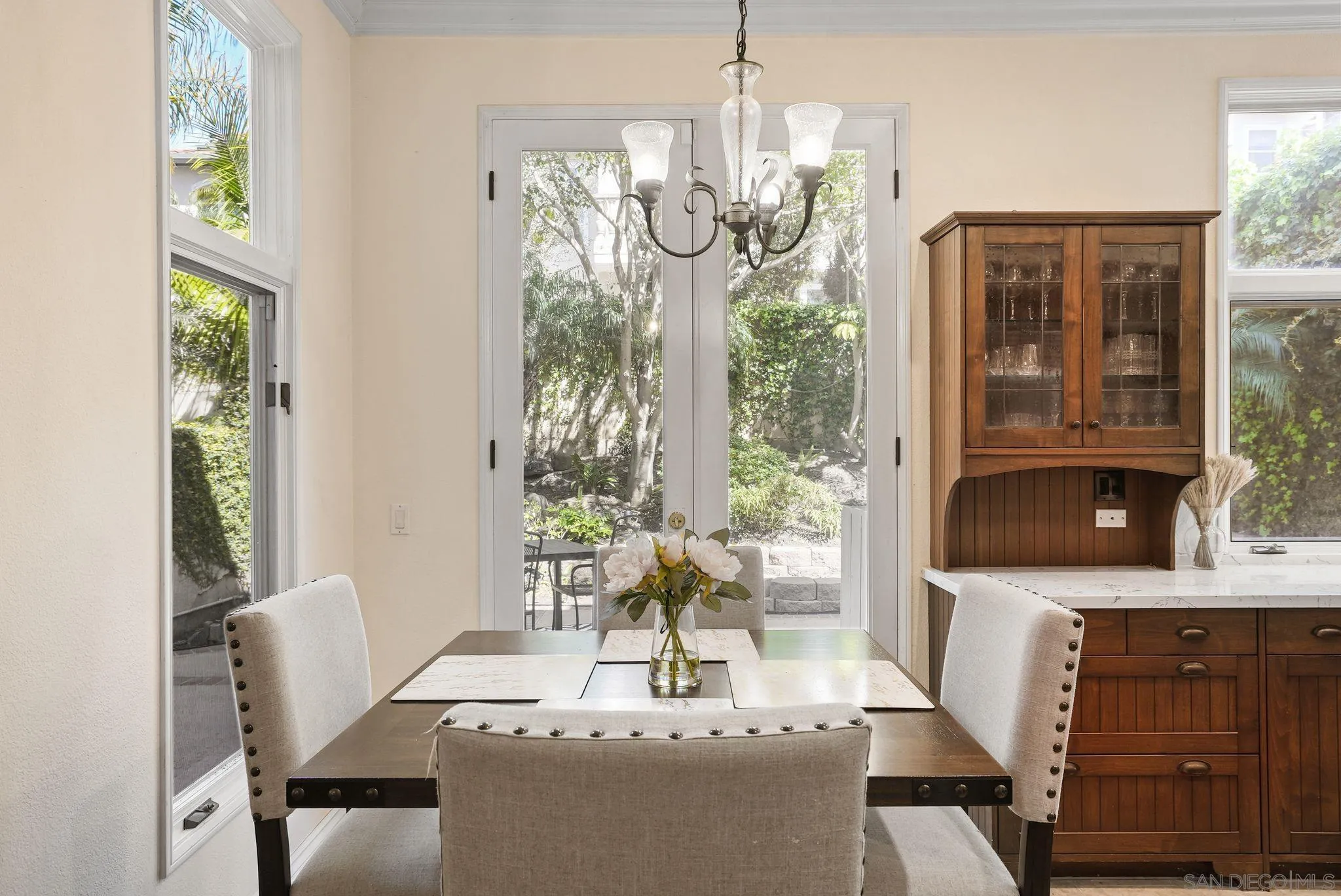 9683 Claiborne Square La Jolla, CA 92037 - Photo 23 of 67 a living room with furniture and a chandelier