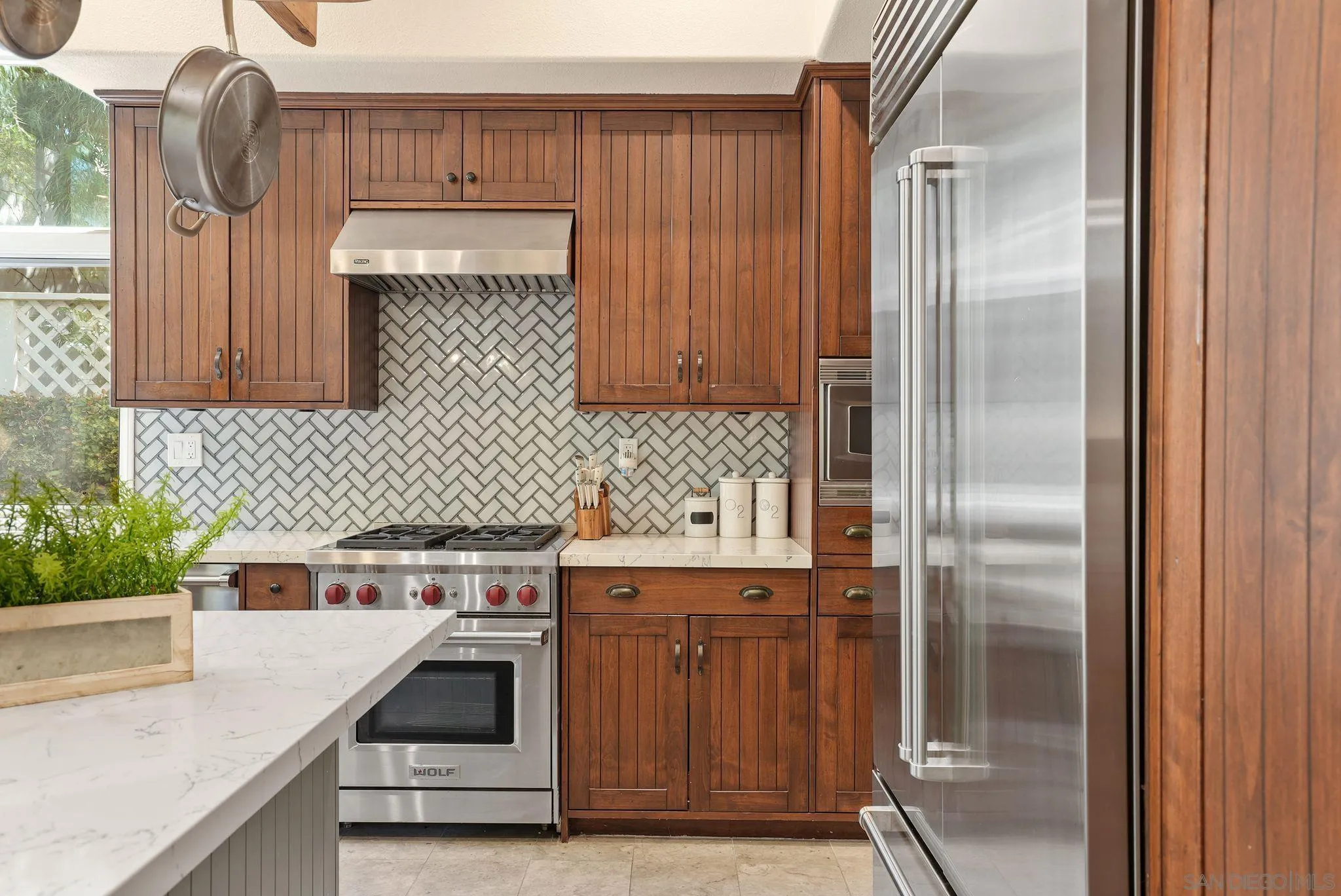 9683 Claiborne Square La Jolla, CA 92037 - Photo 25 of 67 a kitchen with a sink and a refrigerator