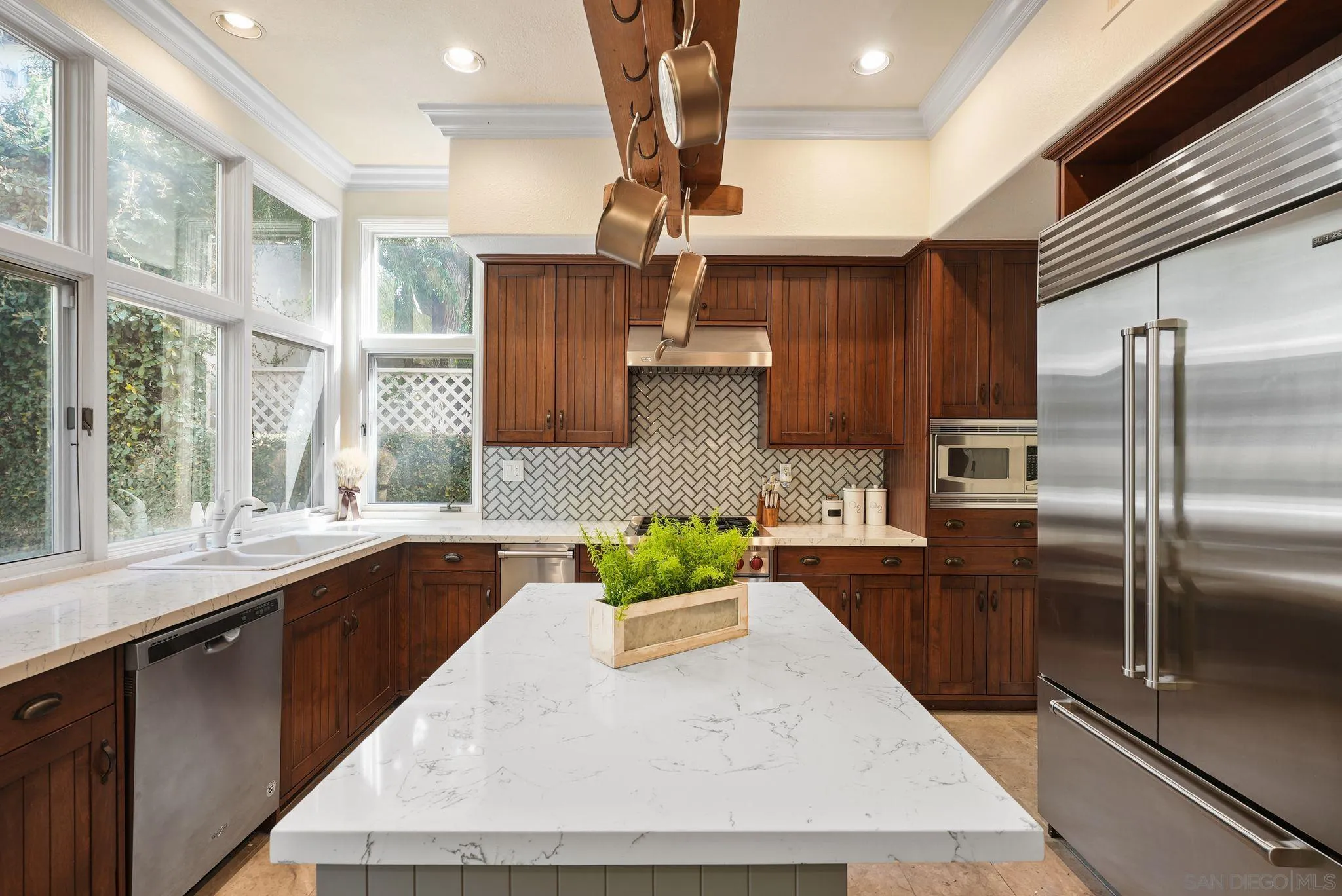 9683 Claiborne Square La Jolla, CA 92037 - Photo 27 of 67 a kitchen with stainless steel appliances granite countertop a sink a stove and a refrigerator