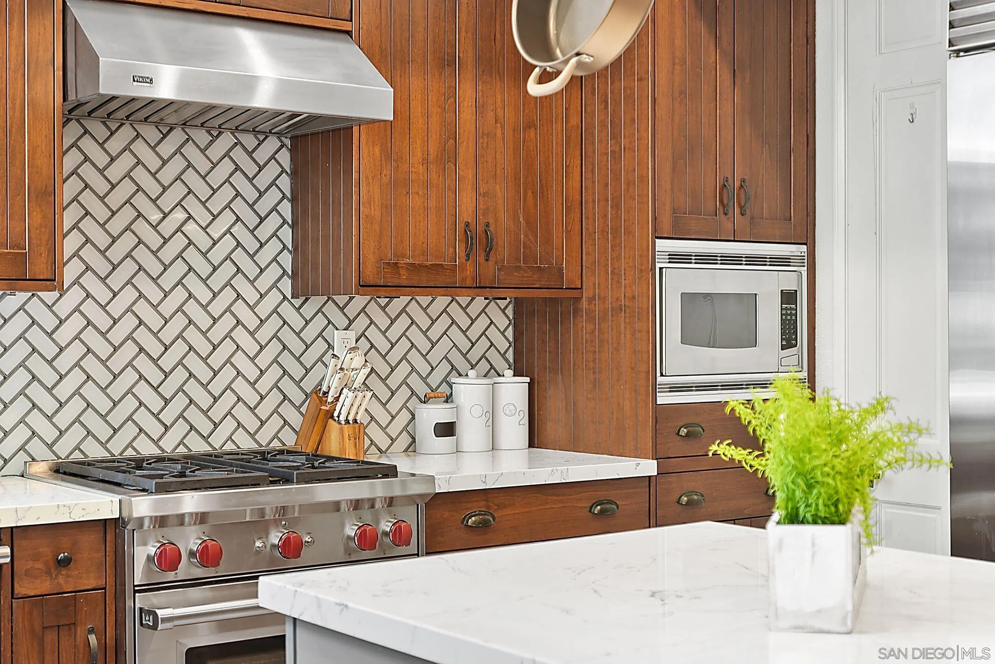 9683 Claiborne Square La Jolla, CA 92037 - Photo 30 of 67 a kitchen with a refrigerator and a sink