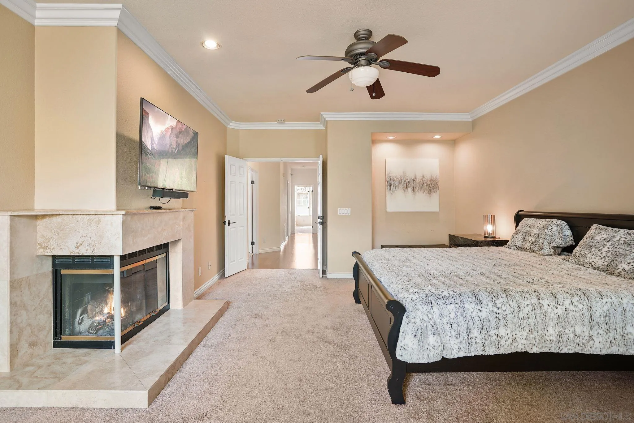 9683 Claiborne Square La Jolla, CA 92037 - Photo 34 of 67 a bedroom with a bed and a chandelier