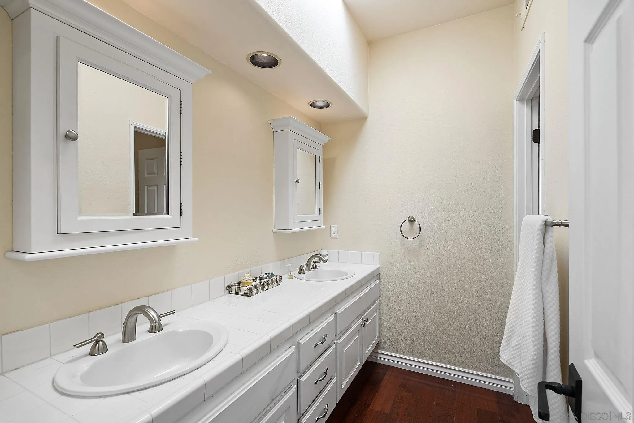 9683 Claiborne Square La Jolla, CA 92037 - Photo 47 of 67 a bathroom with a sink and a mirror