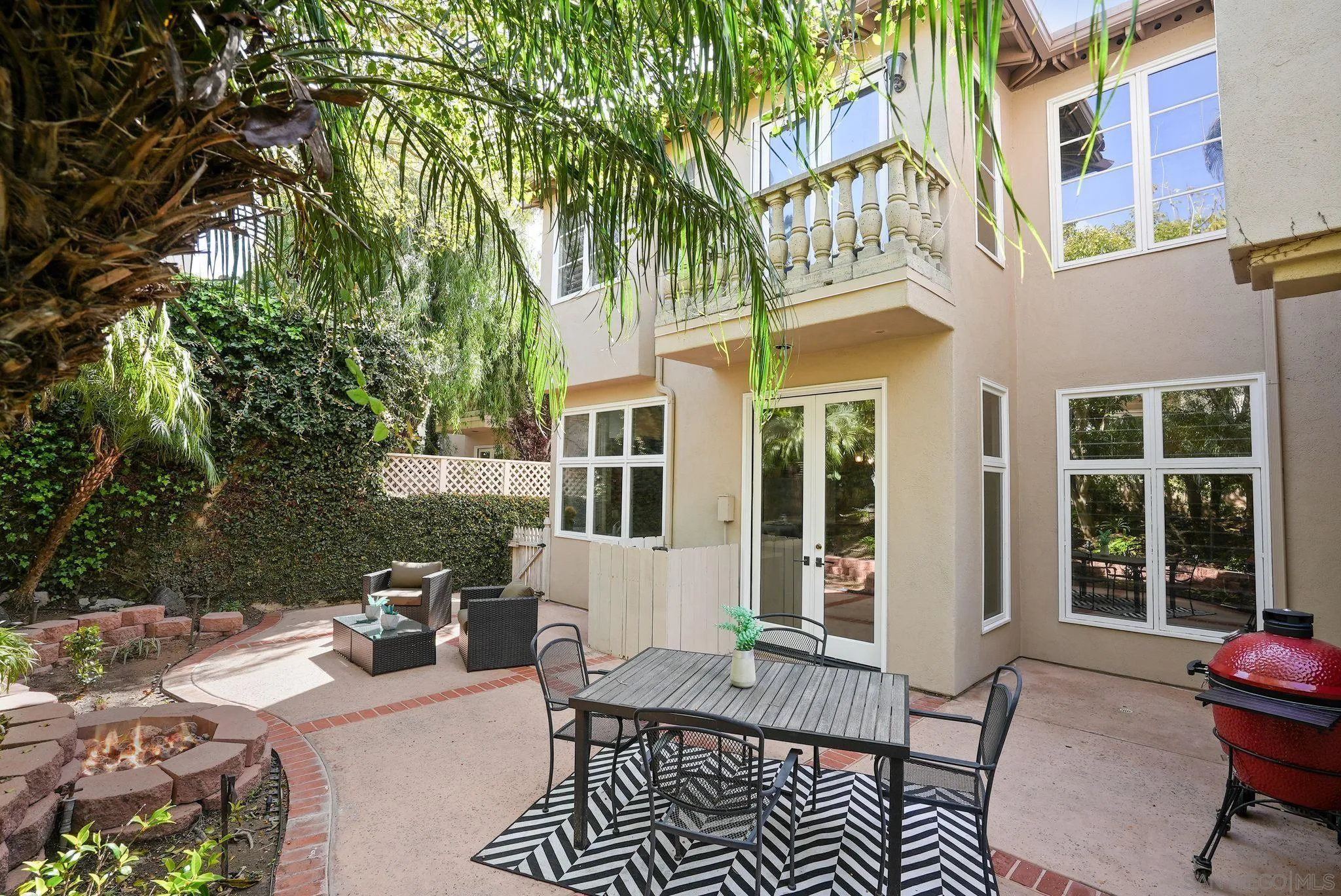 9683 Claiborne Square La Jolla, CA 92037 - Photo 55 of 67 a view of a patio with couches table and chairs and potted plants