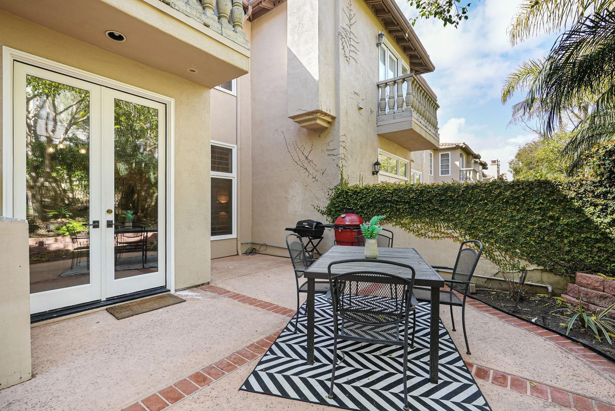 9683 Claiborne Square La Jolla, CA 92037 - Photo 58 of 67 a balcony view with a dining table and chairs with potted plants