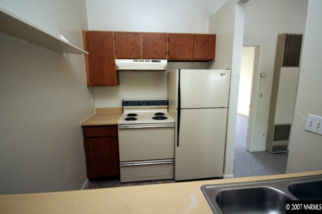490 Highland Avenue, Unit 30 Reno, NV 89512 - Photo 4 of 6 a kitchen with a refrigerator and a sink